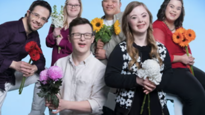 Down for love screenshot 1: A group picture of six cast members holding flowers. 