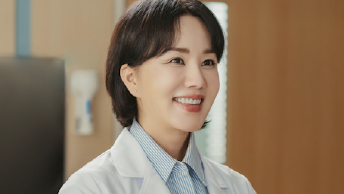 Doctor Cha TV show screenshot 2: Dr. Cha in short hair and med coat looking right and smiling. 
