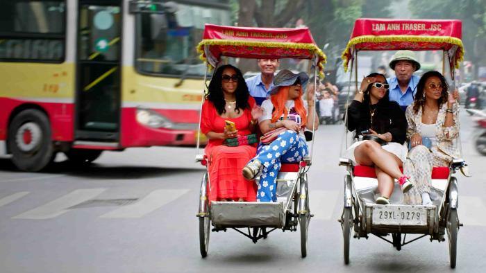 Eat Slay Love TV show screenshot: Two Black women sit next to another two Black women in Tuk Tuks in Thailand.