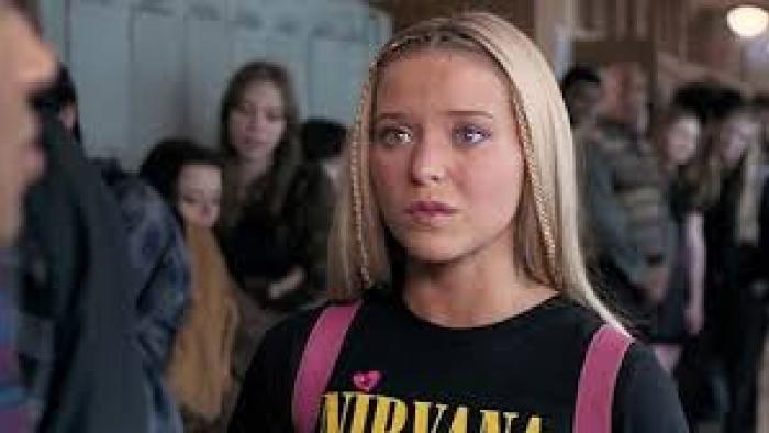 Elle TV show poster: Elle wears a Nirvana t-shirt with her pink backpack