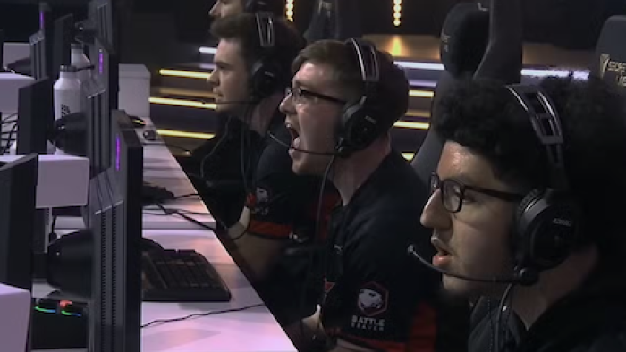 Esports World Cup: Level Up TV show screenshot 2: Gamers in black shirts sitting and playing at monitors. 