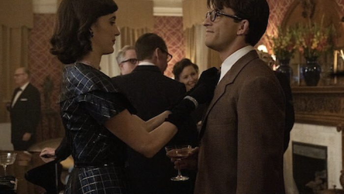 Fellow Travelers TV show screenshot 2: Mary Johnson adjusts Tim's tie at party.