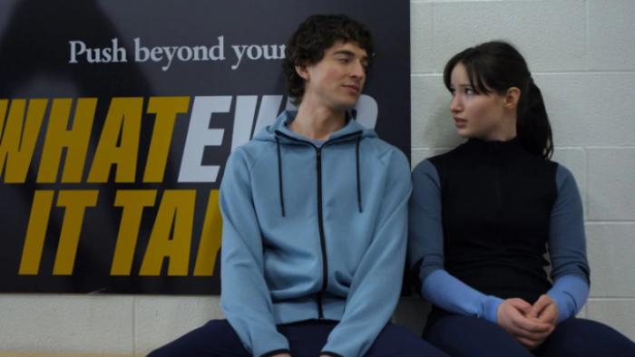 Finding Her Edge: Freddie and Adriana sit together on a bench having a conversation; Adriana looks to be discomfited
