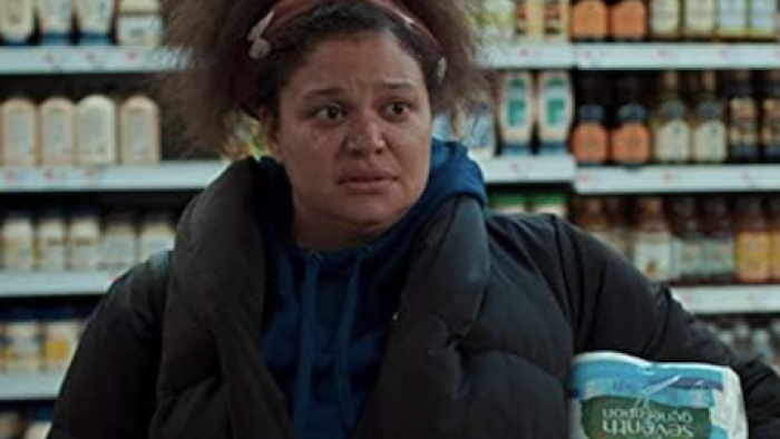 First Wives Club TV show screenshot 2: Exhausted Bree stands in supermarket holding toilet paper. 