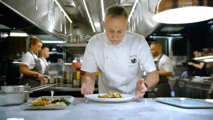 Five Star Chef TV show screenshot 2: head judge Michel Roux Jr. checks chefs' work in the kitchen