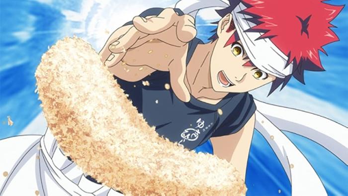Food Wars: A chef with red hair throws bread crumbs on a dish he's making, behind him is a blue background.