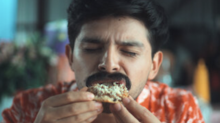 Garnachas: Glorious Street Food! TV show screenshot 3: Peluche Torres bites into a garnacha.