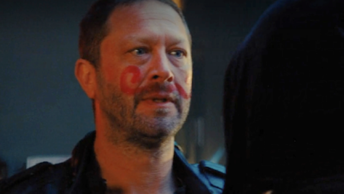 Gary TV show screenshot 3: Mikey with red face markings confronts a hooded Richie in dimly lit bar.