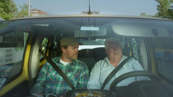 Rainn Wilson and the Geography of Bliss TV show: Rainn Wilson talks with another man in a car