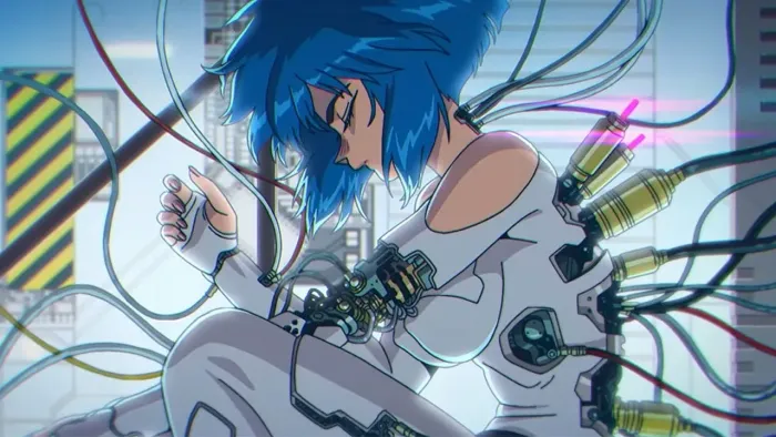 The Ghost in the Shell TV show screenshot 1: A cybernetically enhanced woman connects to cables while seated in a futuristic laboratory. 