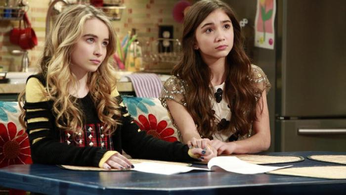 Girl Meets World: Riley and Maya sitting in front of a blue table