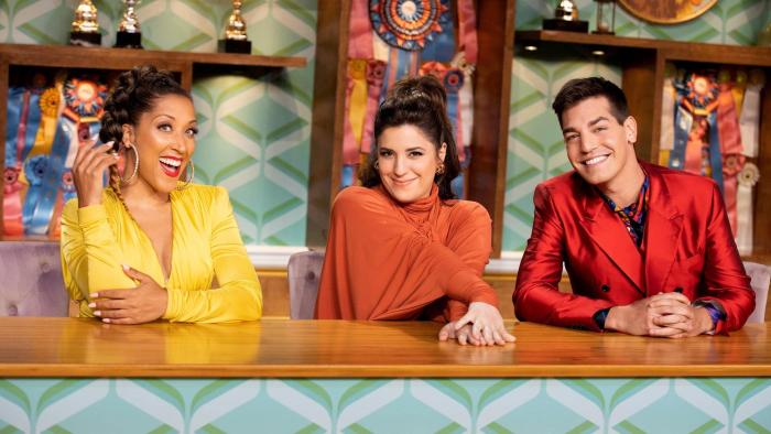 Haute Dog TV Show: Judges Robin Thede and Jess Rona, and host Matt Rogers smile from the judges table