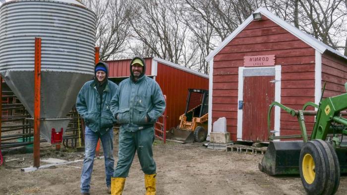 Heartland Docs DVM screenshot: A white man and woman stand near a red shed