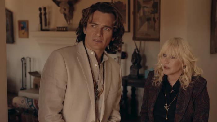 High Desert: Guru Bob and Peggy are shown in a living room, standing close together. He is in all white, she is in black; both look like they've heard bad news
