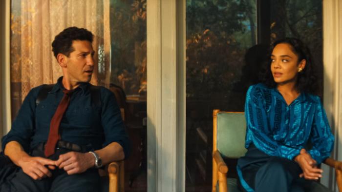His & Hers TV show screenshot 2: Jack and Anna are seated in an office and looking at each other, discomfited by something