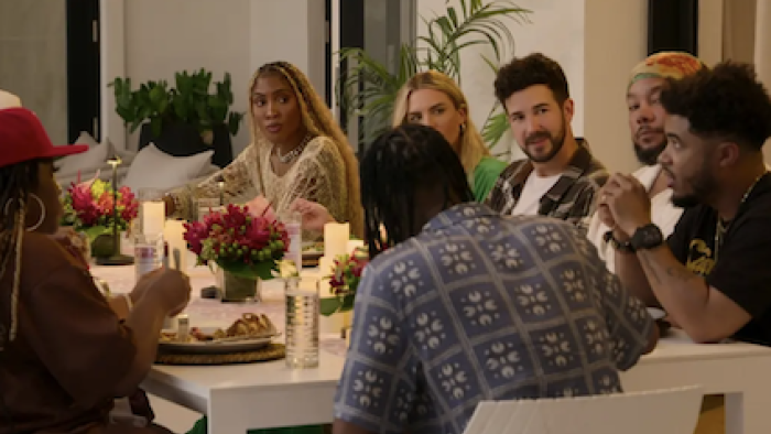 Hitmakers TV show screenshot 1: Songwriters eat together around a dining table. 