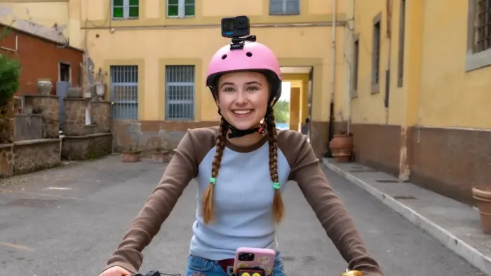 Home Sweet Rome TV show screenshot 1: Lucy riding a bike using a pink helmet through a street in Rome