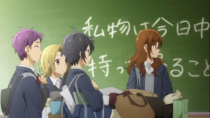 Horimiya TV show screenshot 1: A group of friends stand in front of a chalkboard in their classroom, they have all their school supplies packed up and ready to go.
