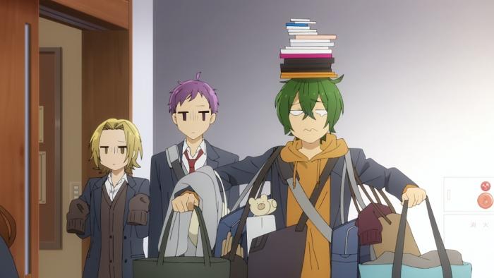 Horimiya TV show screenshot 2: Two students watch with unamused looks as another student balances a large pile of books on their head while holding a bunch of different school bags.