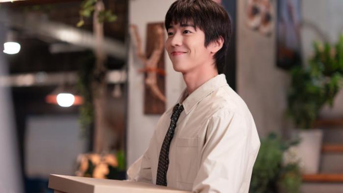 In Your Radiant Season TV show screenshot 3: Chae Jong-hyeop wears a light buttoned-shirt and dark tie. He carries a cardboard box. 