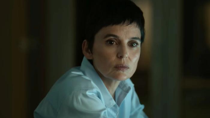 Elena Anaya sits, looking off to the side. She wears a white buttoned shirt.