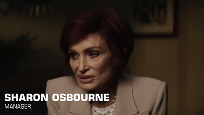 nto the Void TV show screenshot 1: Sharon Osbourne is pictured in a khaki-colored blazer, pictured from the shoulders up and looking offscreen.