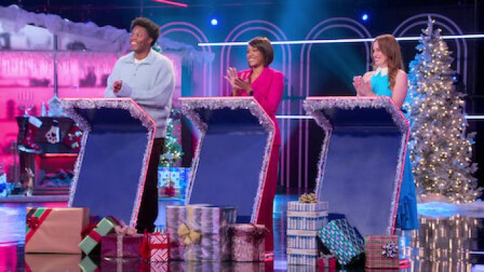 Is It Cake? Holiday TV Show screenshot 4: Judges Hannah Berner, Tiffany Haddish, and Devon Walker stand at podiums