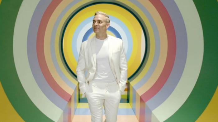 It's OK to Ask Questions: Matthew Rodrigues is shown in the center of colorful rings 