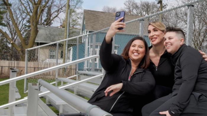 It's OK to Ask Questions: Three friends take a selfie together, holding the camera high