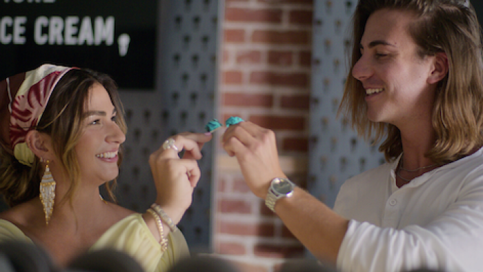 Jewish Matchmaking TV show screenshot 3: Young woman shares spoon of ice cream with date. 