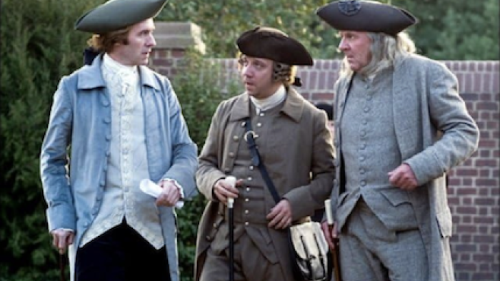 John Adams screenshot 3: Thomas Jefferson, John Adams, and Benjamin Franklin stand together speaking. 