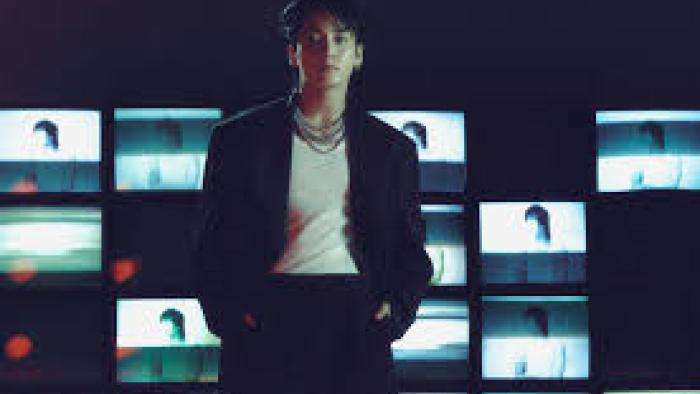 Jung Kook: I Am Still TV show screenshot #2: Jung Kook stands in front of lit images