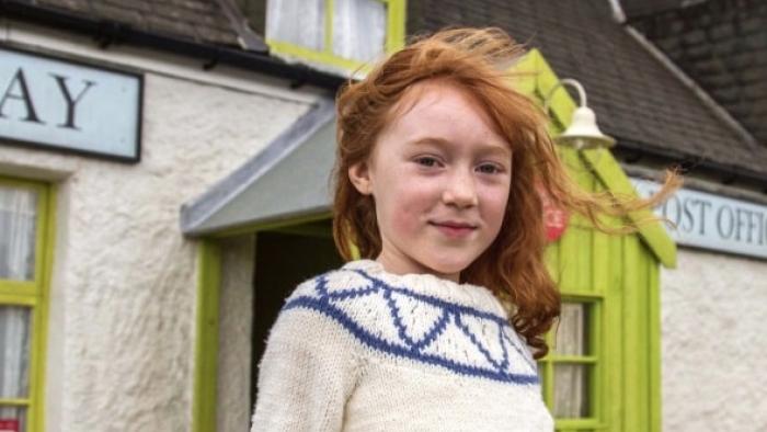 Katie Morag TV Series: Katie in front of the Struay village store and post. 