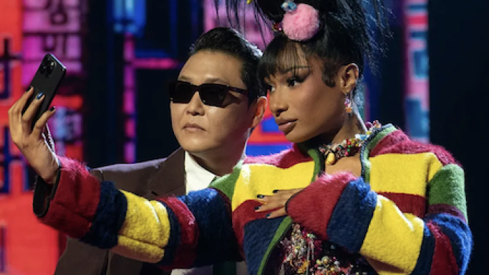 KPOPPED screenshot 1: PSY and Megan thee Stallion holding phone and taking selfie. 