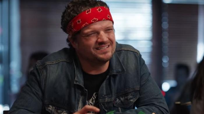 Let's Get Physical Series: A man in a denim jacket with a bandanna around his forehead squints into the camera. 