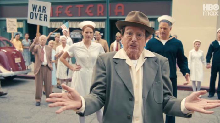 Life, Larry and the Pursuit of Unhappiness screenshot 1: David, dressed in WWII-era clothing, gestures helplessly during the 1946 U.S. Victory Parade