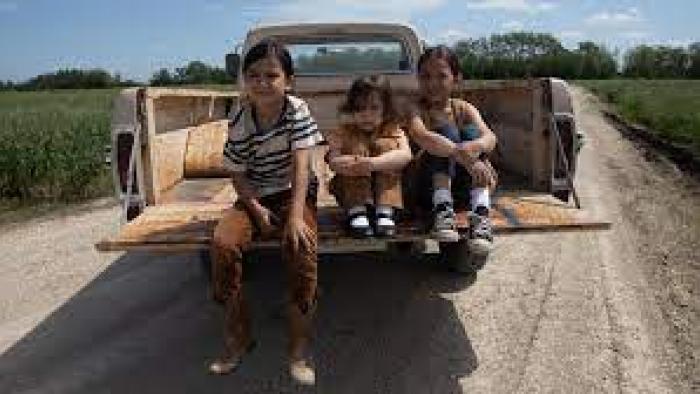 Little Bird TV show screenshot #2: Children sit in the back of a pickup truck
