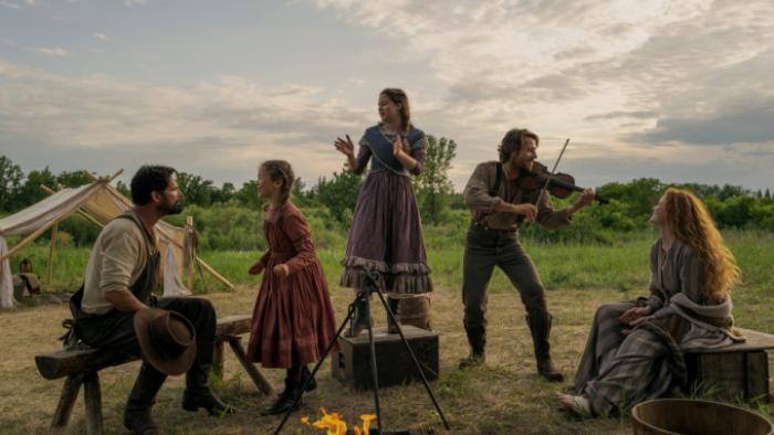 Little House on the Prairie TV show: Charles plays his fiddle as the Ingalls family members listen and sit on the prairie