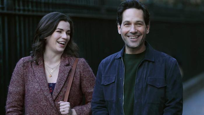 Living with Yourself Series: Kate and Miles grin happily as they stand together in an outdoors shot. 