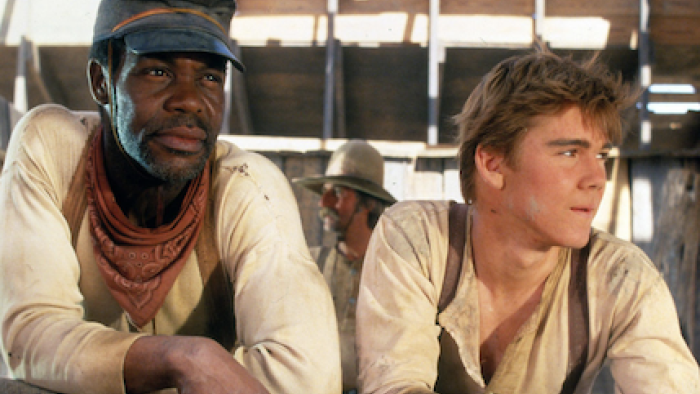 Lonesome Dove TV show screenshot 3: Joshua Deets and Newt Dobbs sit together wearing white shirts and suspenders.