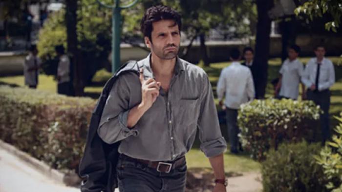 Love 101 screenshot 3: Kemal walks into the school, wearing a grey button-down shirt. He has a jacket slung over his shoulder
