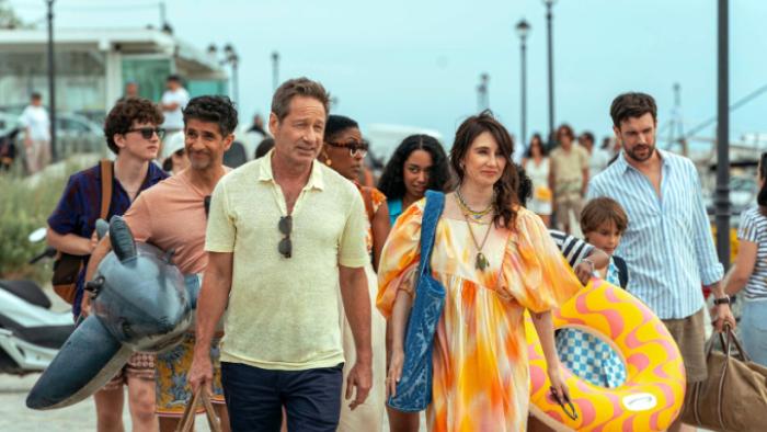 Malice TV show screenshot 1: The Tanner family, Jules, Damien, Milly, and Adam all walk to the beach carrying floaties and towels