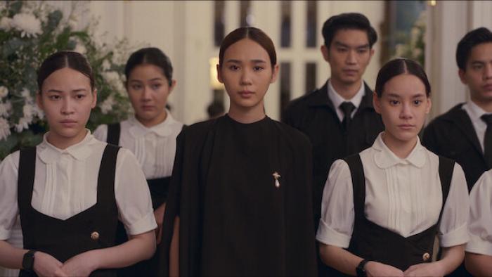 Master of the House TV show screenshot 1: a group of formally dressed young people stand together, looking grim.
