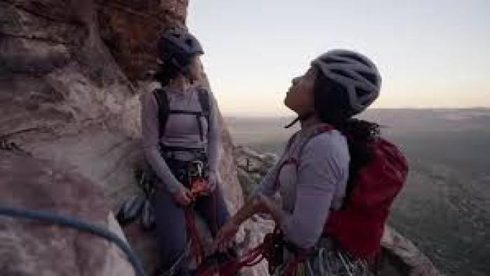 Memphis to the Mountain TV show screenshot #1: two people stand on the side of mountain in climbing gear