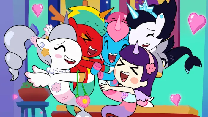 Mermicorno Starfall TV: A group hug of the friends Astra, Nautique, Squishella, Kameko and Gwen. Pink hearts float around them.