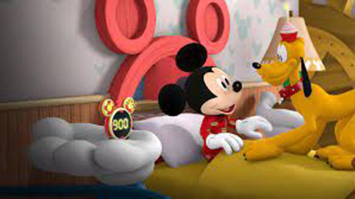 Mickey Mouse: Hot Diggity Dog Tales - Mickey is in bed with Pluto sitting in front of him and a clock next to them that says 9:00