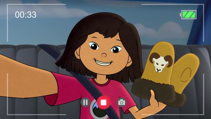 Molly's Epic Adventures TV: Molly records a selfie video of herself waving a part of mittens in the backseat of a car.