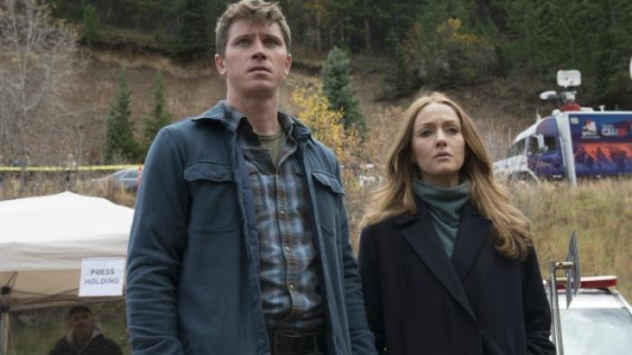 Mosaic Series: A man and a woman are standing together in front of a mountain with a news van parked just over their shoulder; both look upset. 
