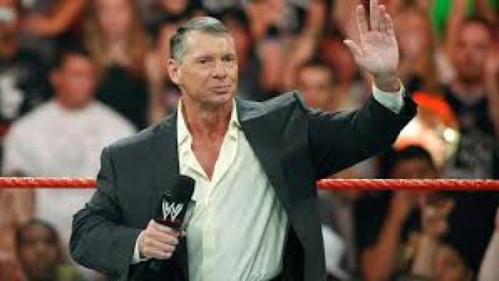 Mr. McMahon TV show screenshot: Vince McMahone is shown standing in a ring with crowds behind him while holding a microphone