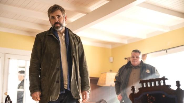 Murder in a Small Town: Two men looking at at something with concerned expressions. Photo take from below so both men appear to be looking down. 